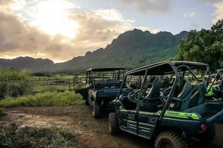 Green 4x4 UTVs parked at Sunset on Hawaii