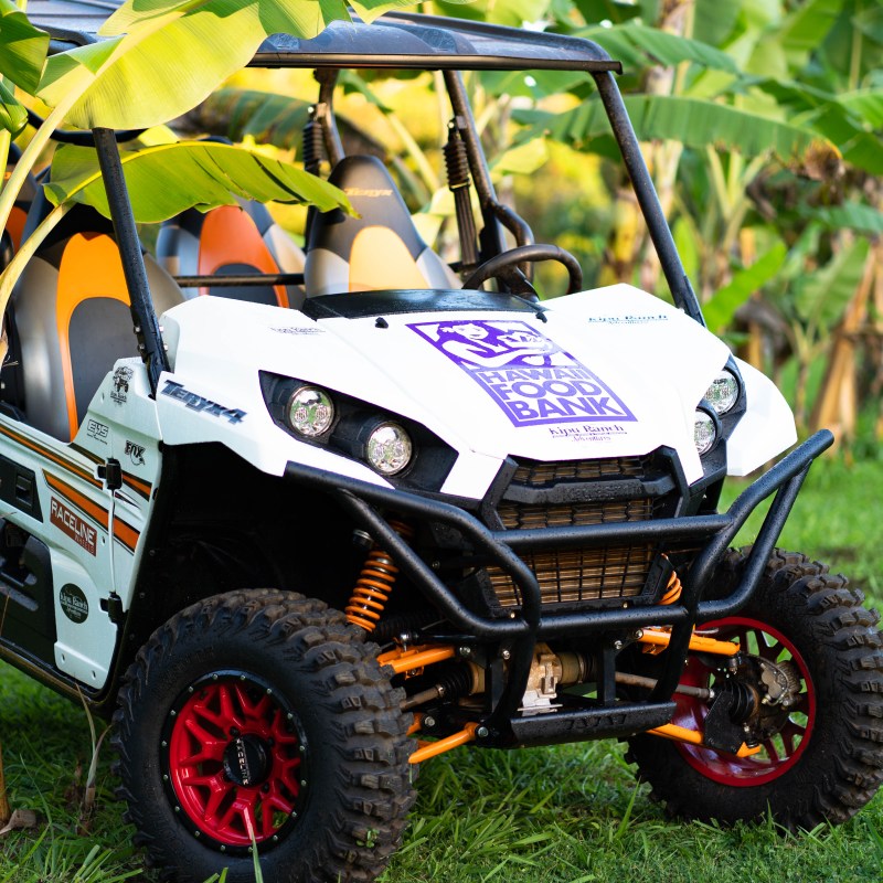 a truck cake sitting on top of a grass covered field